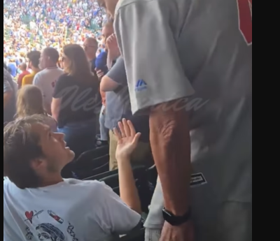 Older man slaps fan